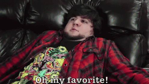 a man in a plaid shirt is laying on a couch and says " oh my favorite "