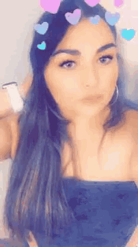 a woman with hearts on her hair is taking a selfie .