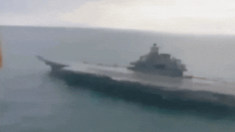a blurred image of a military ship in the ocean