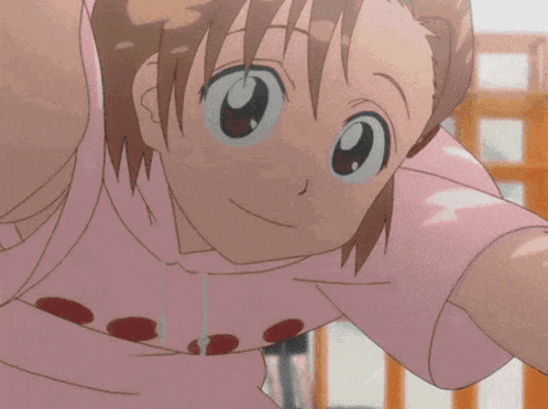 a girl in a pink shirt with red polka dots on it