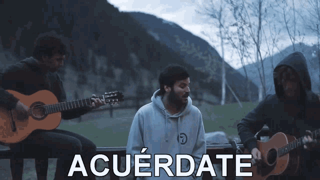 three men playing guitars in front of a mountain and the words acuerdate above them