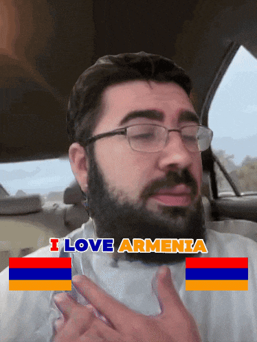 a man wearing glasses and a beard says i love armenia