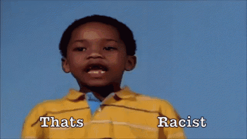 a young boy in a yellow shirt is screaming with the words thats racist behind him