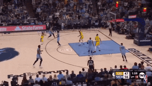 a basketball game is being played in front of a fedex forum ad