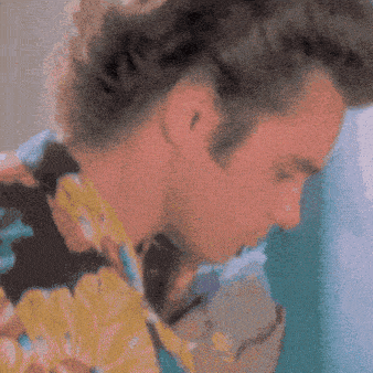 a close up of a man 's face in a hawaiian shirt