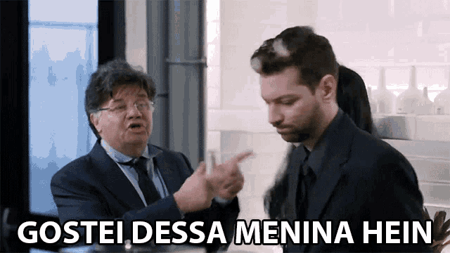 a man in a suit is pointing at another man with the words gostei dessa menina hein written below him
