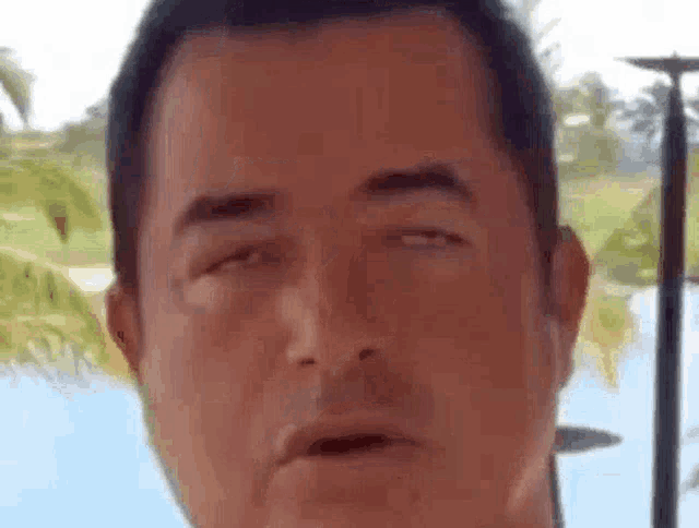 a close up of a man 's face making a funny face .