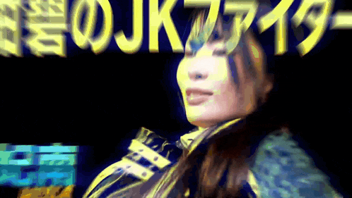 a woman in front of a sign that says jk