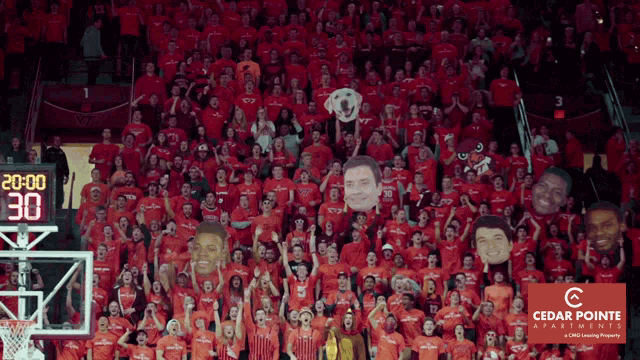 a crowd of people wearing red shirts with a cedar pointe logo in the corner