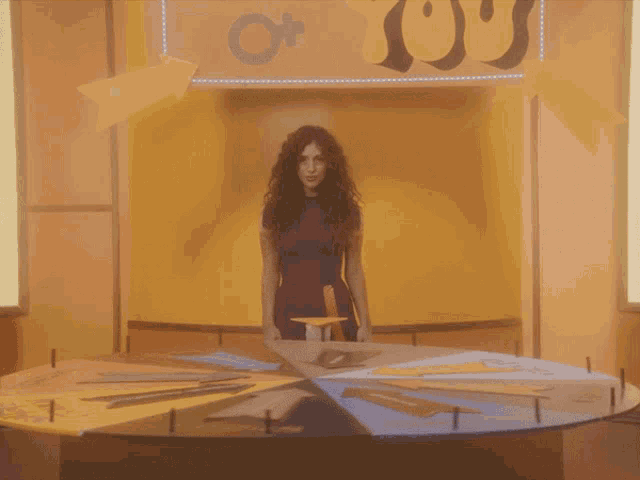 a woman is standing in front of a sign that says you