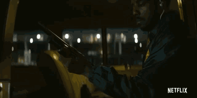 a man driving a car with netflix written on the bottom of the screen