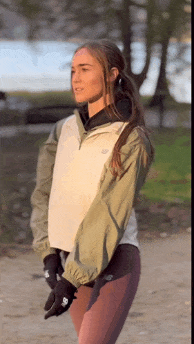 a woman wearing a jacket that says new balance