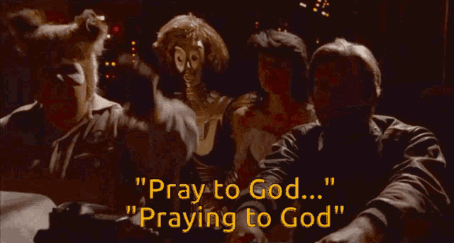a group of people sitting in a dark room with the words pray to god praying to god on the bottom