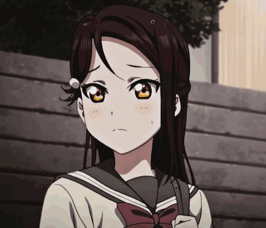 a girl with brown hair and orange eyes is wearing a sailor uniform