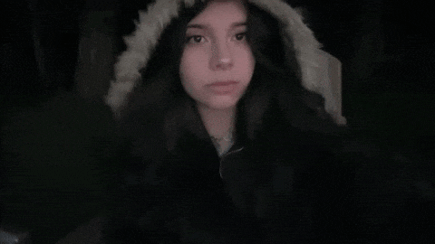 a girl wearing a fur hooded jacket looks at the camera