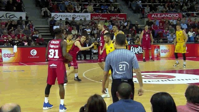 a basketball player with the number 31 on his jersey stands on the court