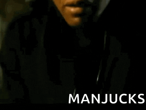 a close up of a man 's face with the word manjucks written below him