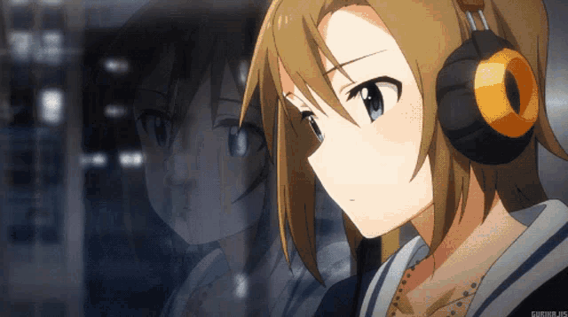a girl wearing headphones looks at her reflection in a mirror