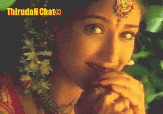 a close up of a woman 's face with the words " thiruda chat " on the bottom