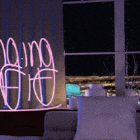 a living room with a neon sign that says doing