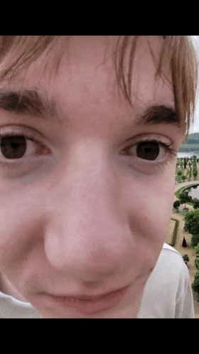 a close up of a person 's face with a blurred background