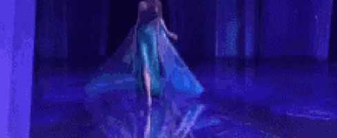 a woman in a blue dress is dancing on a stage .