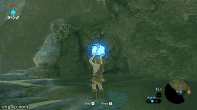 a screenshot of a video game shows a person standing in front of a large blue sphere .