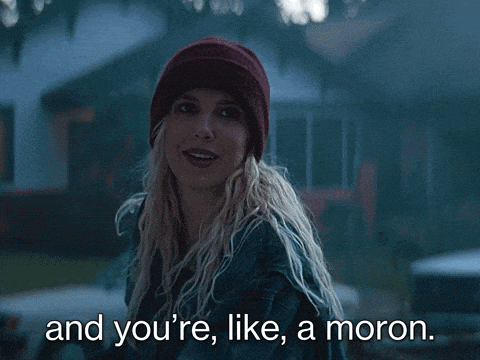 a woman wearing a beanie and a jacket says " and you 're like a moron "