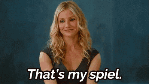 a woman in a blue dress is smiling and says `` that 's my spiel '' .