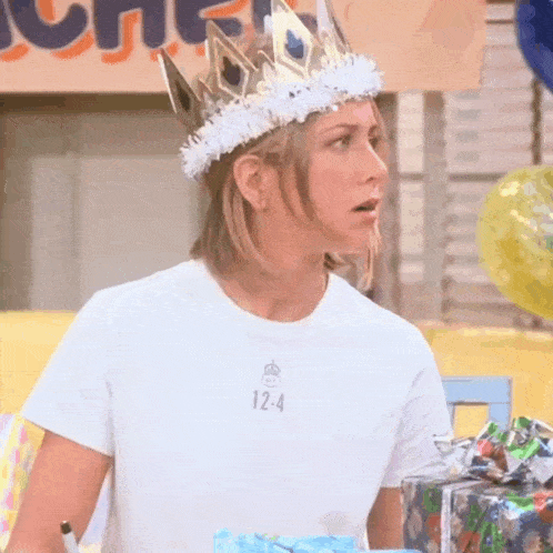 a woman wearing a crown and a white t-shirt with the number 12-4 on it