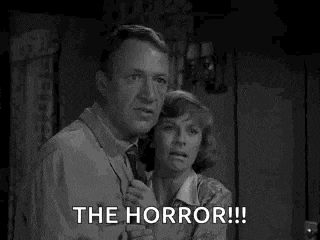 a man and a woman are standing next to each other in a black and white photo .