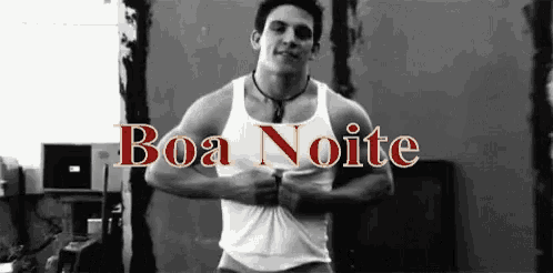 a man is standing in front of a sign that says boa noite .