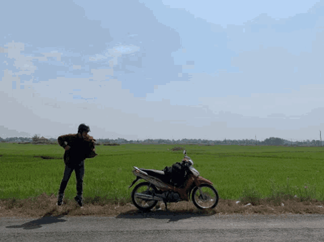 a person standing next to a motorcycle that says yamaha on the side