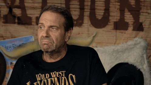 a man wearing a wild west legends t-shirt