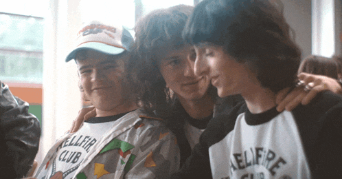 three young men are posing for a picture and one of them is wearing a shirt that says keller club
