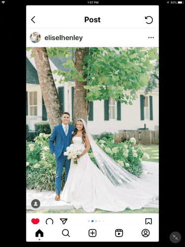 a bride and groom are posing for a photo in front of a house
