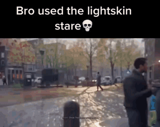a man is walking down a street in a video game while a skull is on the screen .