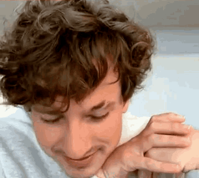 a close up of a man 's face with his eyes closed and his hand on his neck .