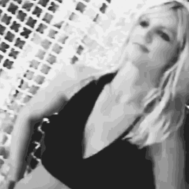 a black and white photo of a woman in a bikini .