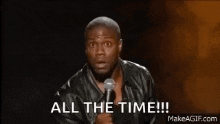 a man is holding a microphone in his hand and saying `` all the time '' .