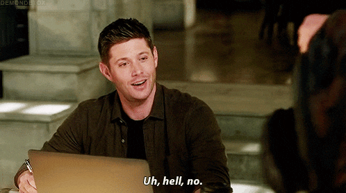 a man is sitting at a desk with a laptop and says uh hell no