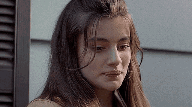 a close up of a woman 's face with long hair