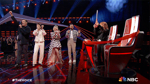 a group of people standing on a stage with nbc written on the bottom