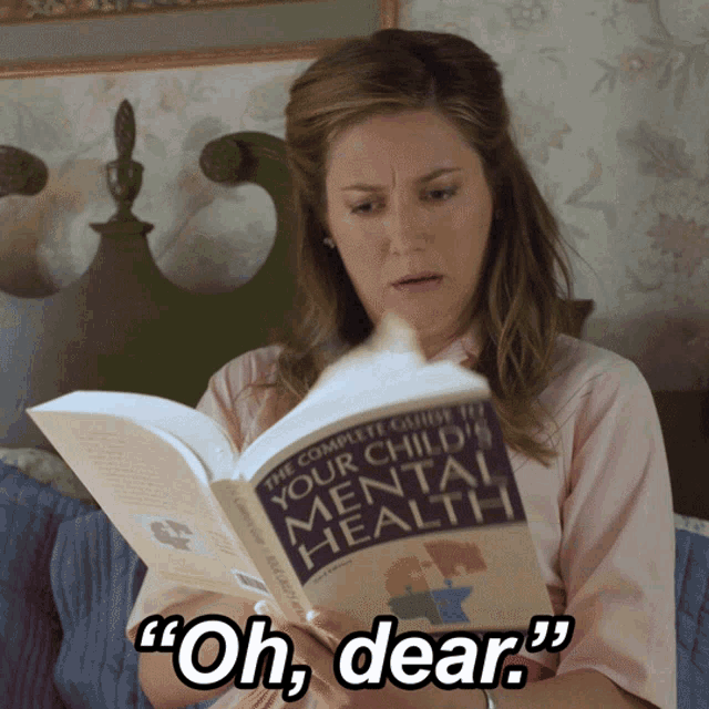 a woman is reading a book about mental health