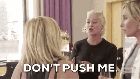a woman says do n't push me while talking to two other women
