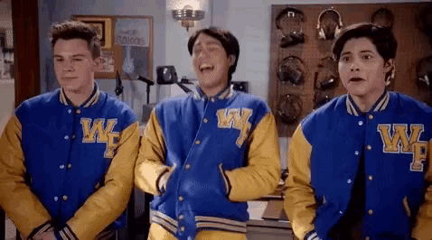three boys wearing blue and yellow varsity jackets with the letter w on them