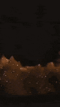 a close up of a flame in the dark