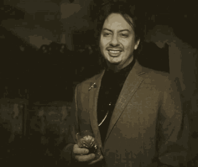 a man in a suit holds a glass and says " oh no thank you "