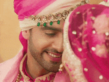 a close up of a man wearing a turban and necklace