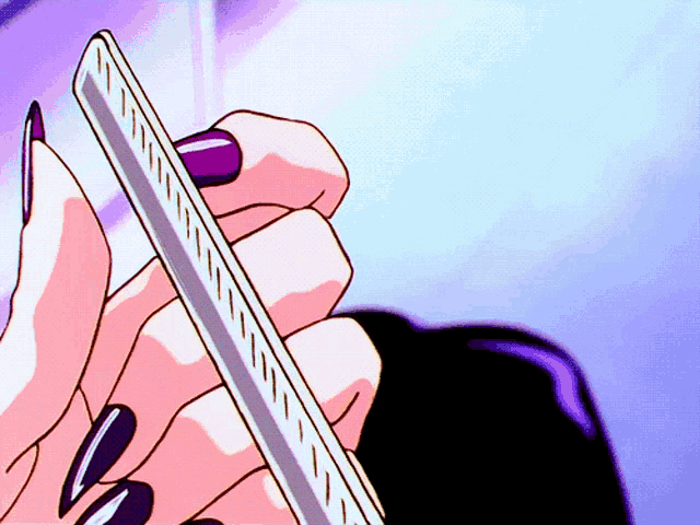 a woman with long black nails is holding a ruler in her hand
